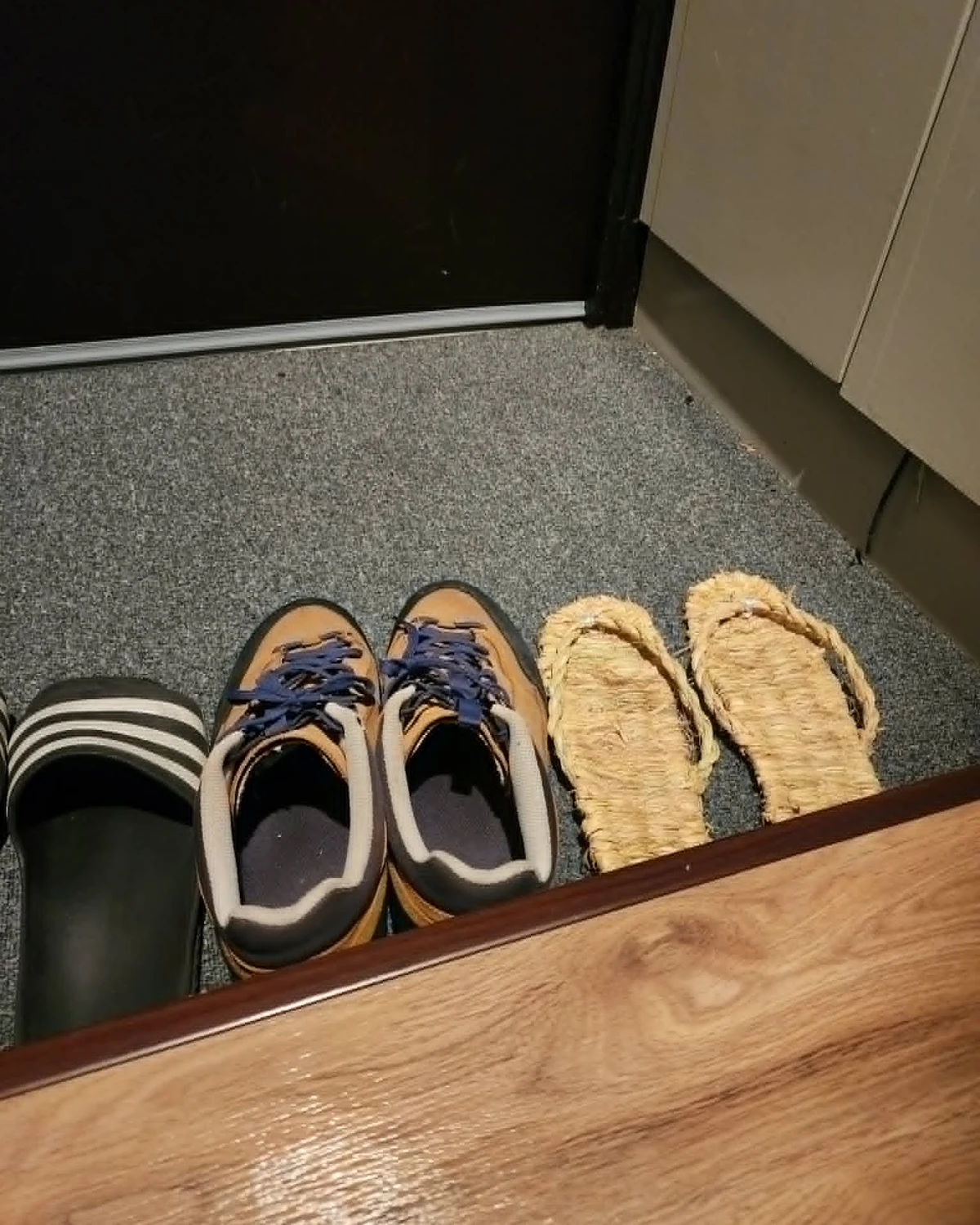 Un genkan traditionnel japonais, avec des chaussures alignées devant l’entrée